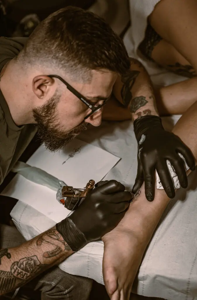 colour realism tattoo artist tattooing someones foot