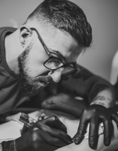 Tattoo artist at Inception Ink tattoo studio Essex working on client