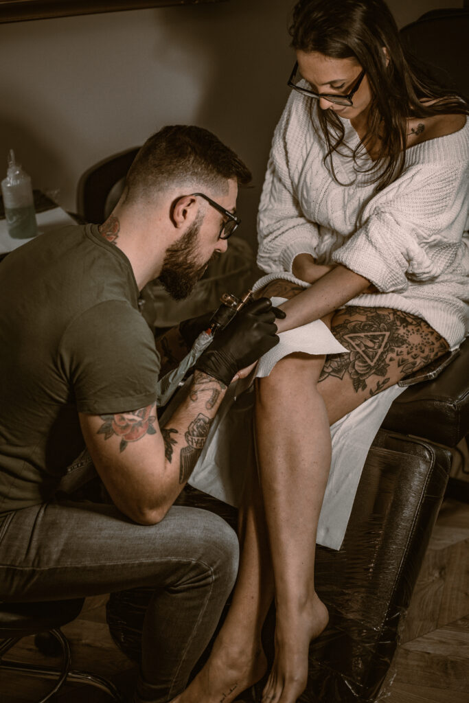 tattooist in Essex, chelmsford shop, tattooing a client on her wrist